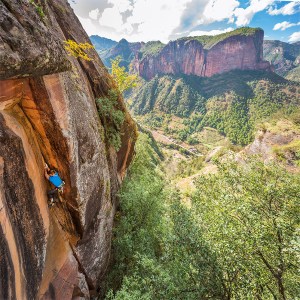Mike Dobie works the thin finger section on the first free ascent of The Last Ninja (5.12) in Liming, China.