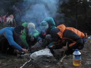 Group effort to make fire in the wet